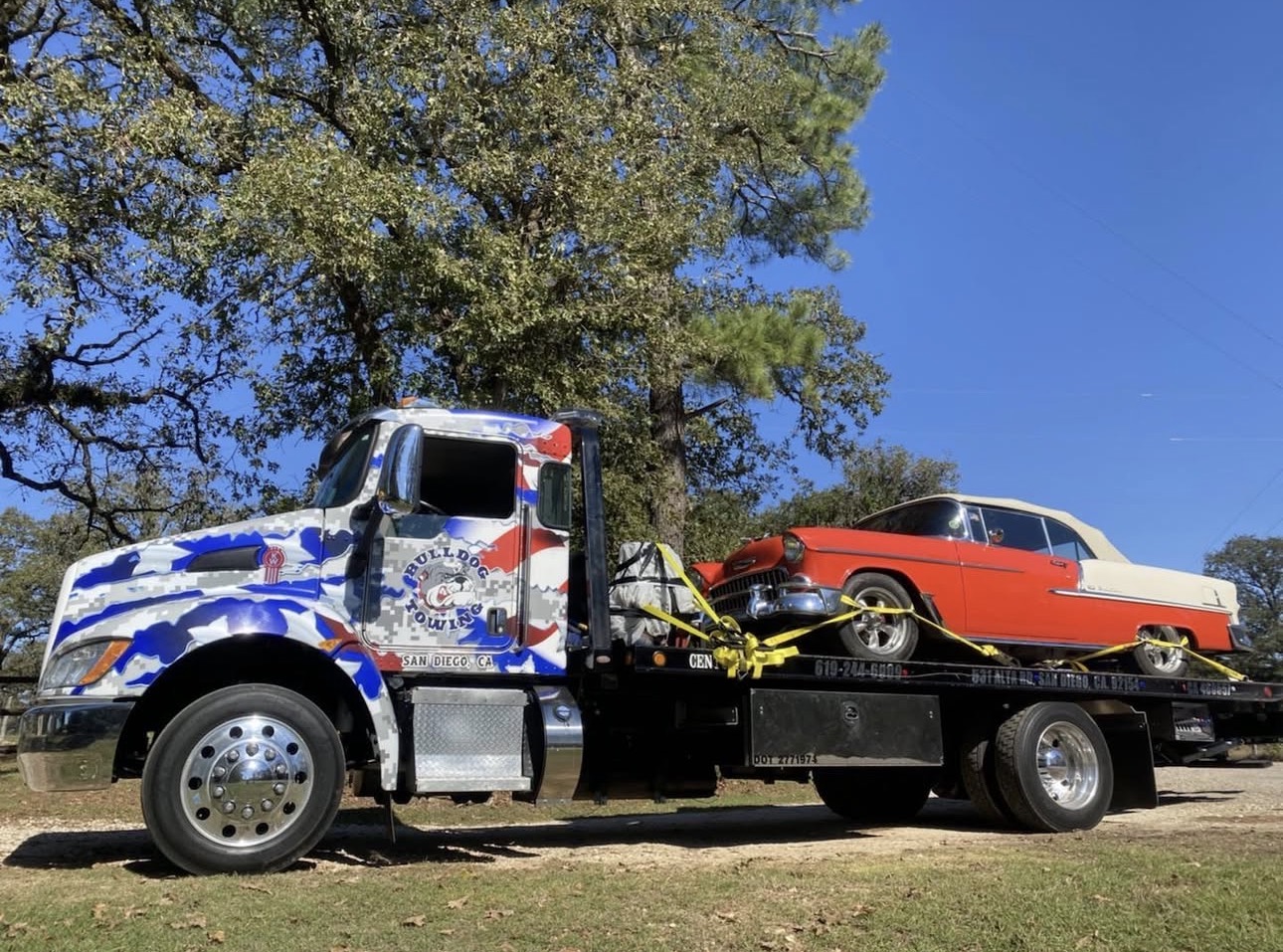 Bulldog Towing transporting a classic vehicle on a flatbed truck with professional tie-down and securement.