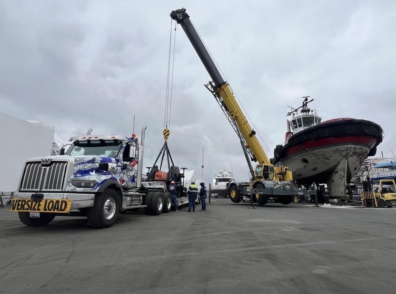 Bulldog Towing assisting with a crane-supported recovery operation involving oversized equipment.